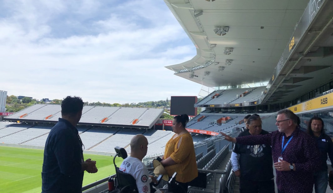 Eden Park. Dayna & Peta looking out  over the field from the main grandstand towards the south stand.  Accessibility evaluation 2019 in preparation for Te Matatini event